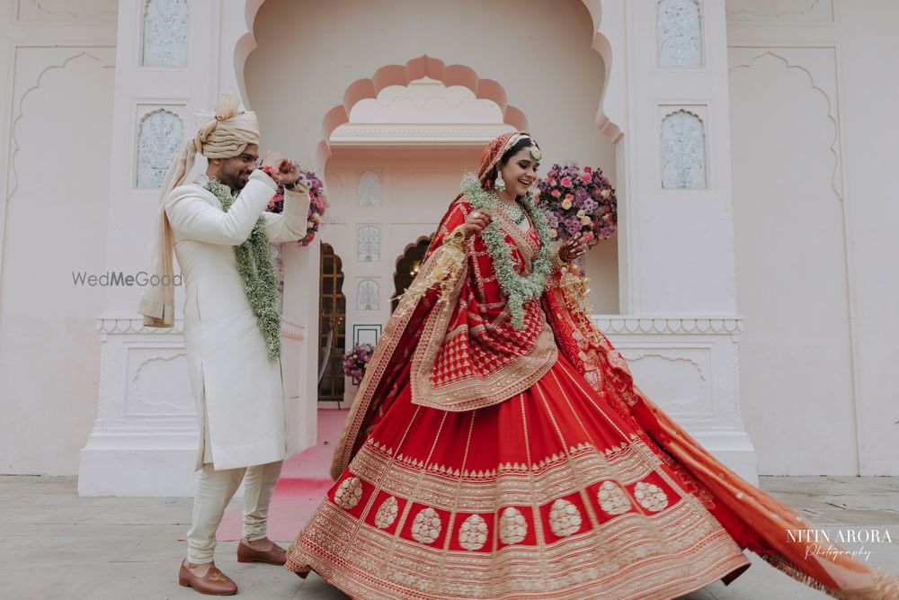 Photo of twirling bride shot in sabyasachi lehenga