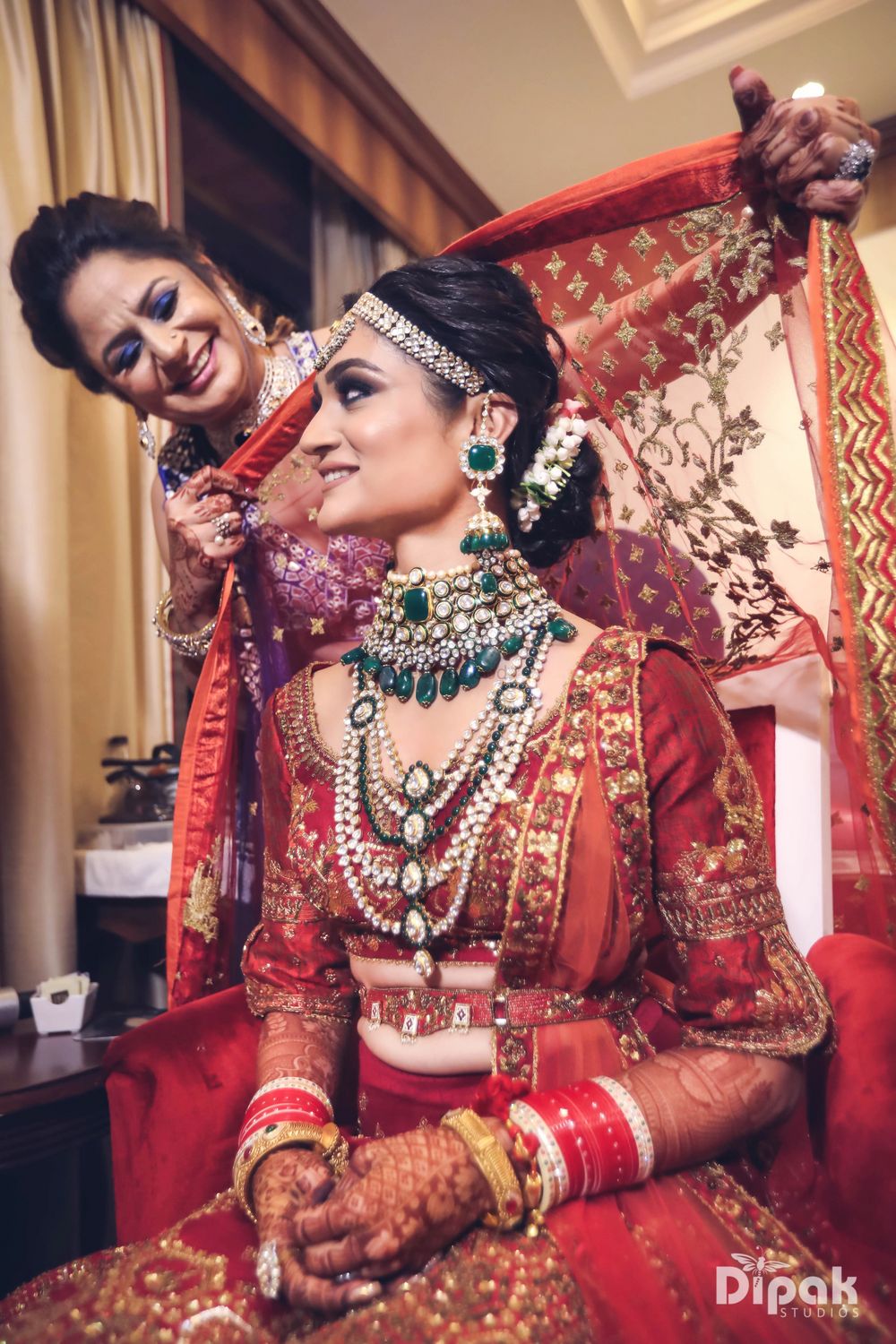 Photo of Bride with mother placing dupatta on head