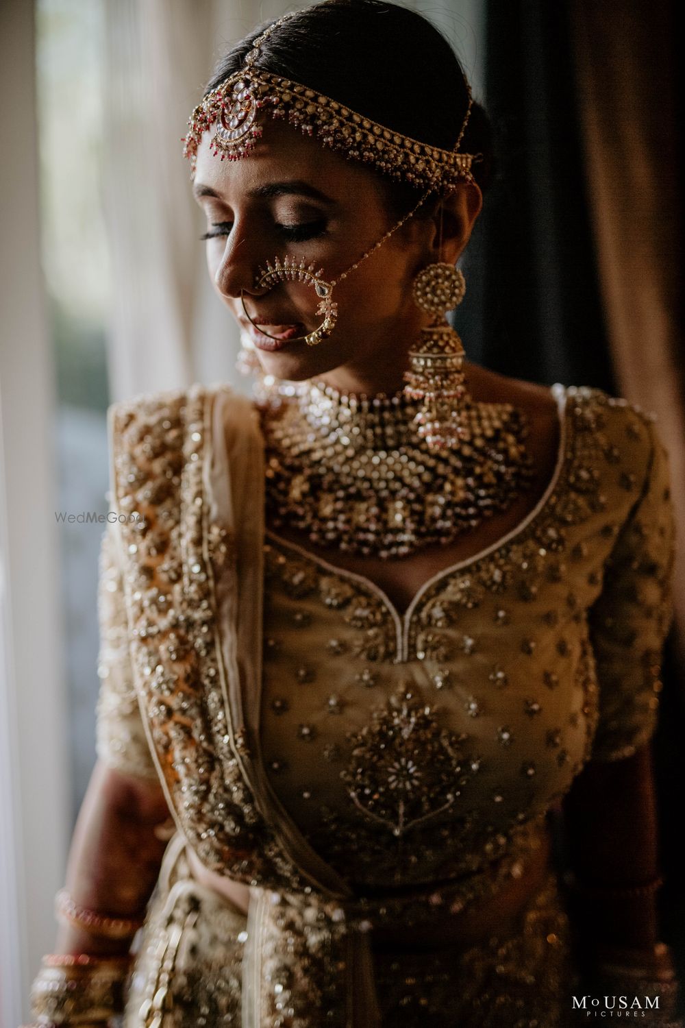 Photo of bridal close up shot with gold jewellery and lehenga