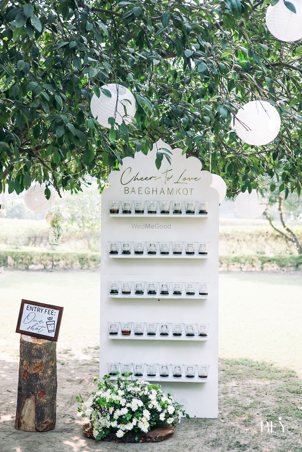 Photo of unique wedding station idea - shot wall seating chart
