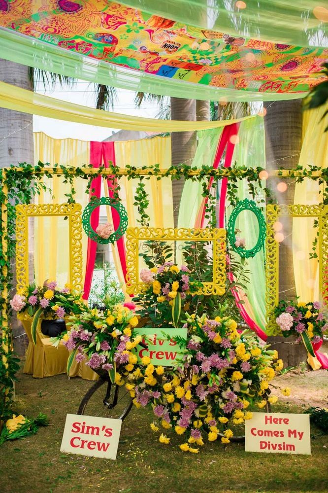 Photo of Yellow and green photobooth with frames