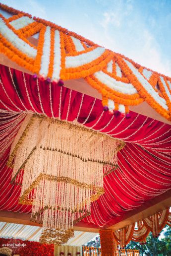 Photo of orange red and white mandap