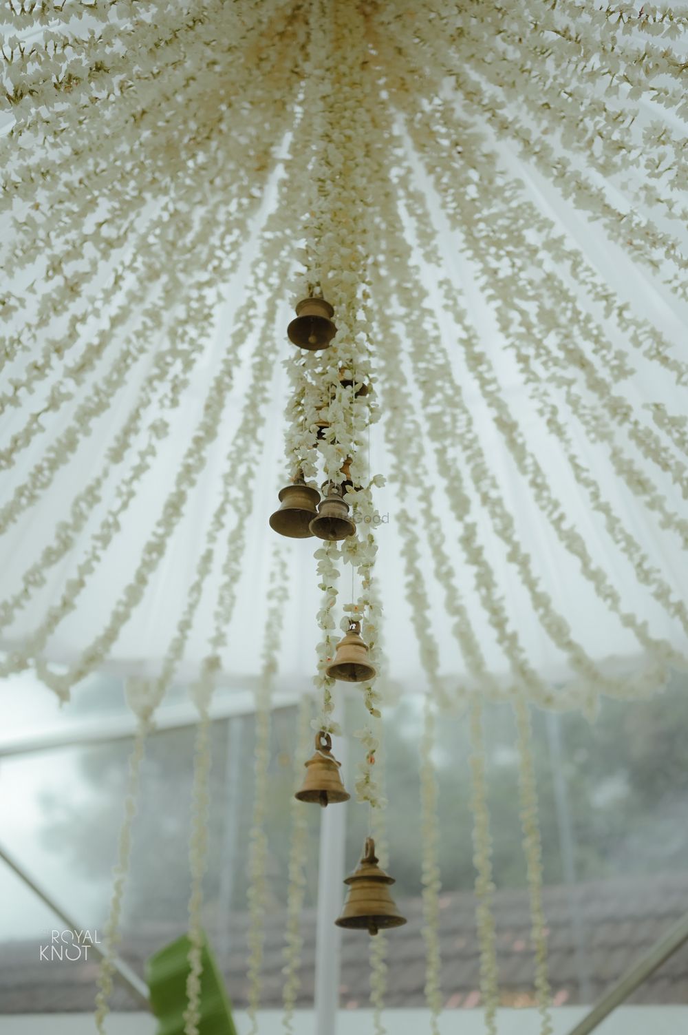 Photo of simple mandap at home with mogra strings and temple bells