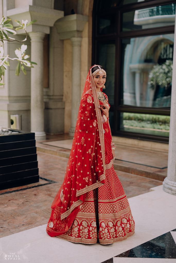Photo of A bride in a red bridal lehenga