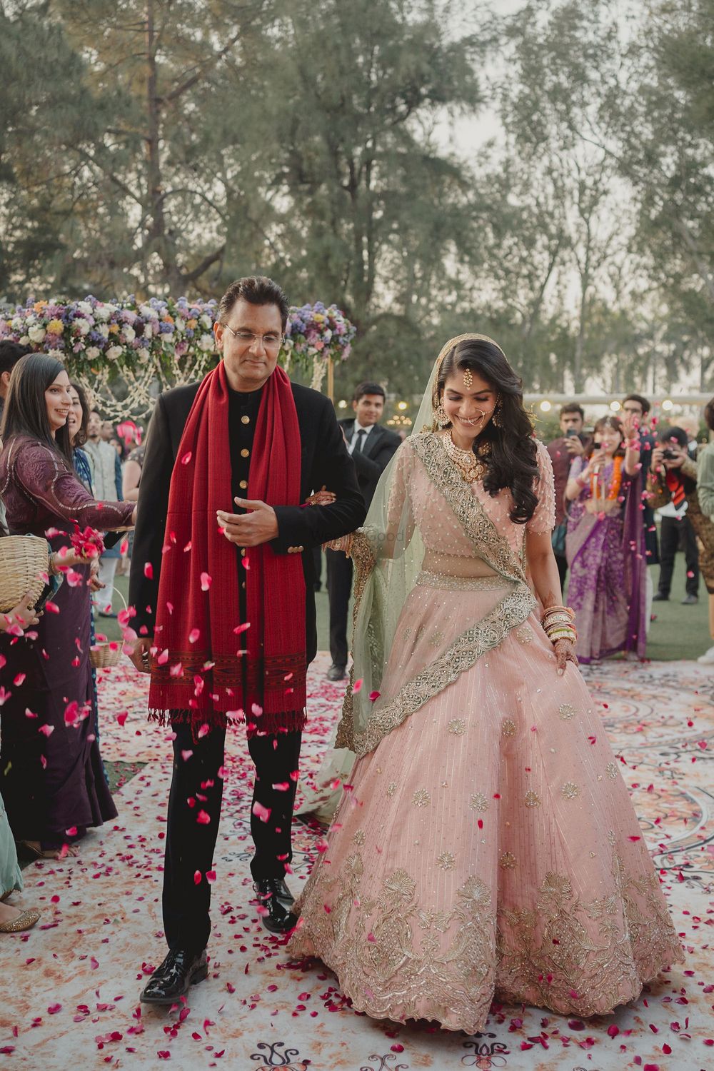 Photo of bride entering with her father to mandap