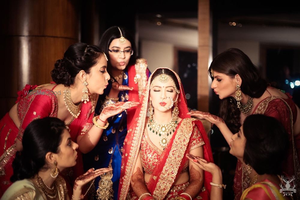 Photo of Bride with Bridesmaids Blowing Kisses at Her