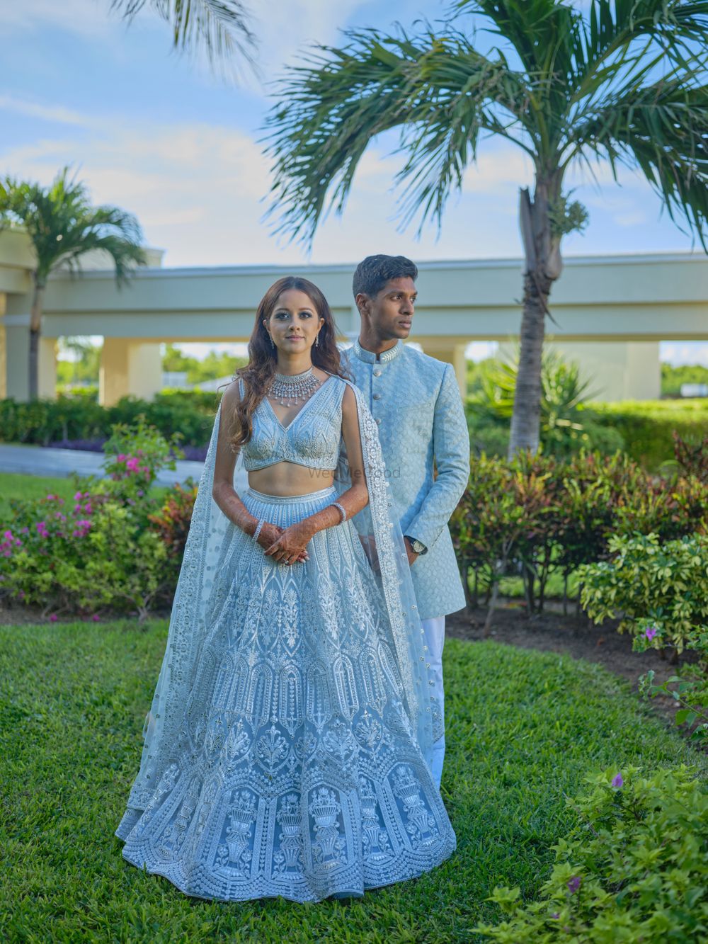 Photo of twinning bride and groom in powder blue for sangeet