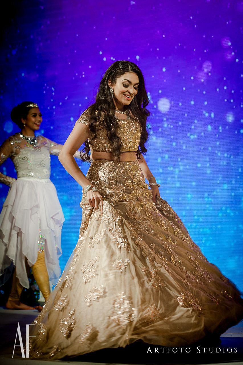 Photo of Bride dancing n gold embellished lehenga