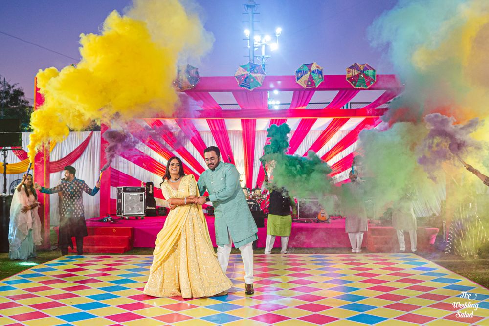 Photo of mehendi or sangeet idea with smoke bombs during couple dance