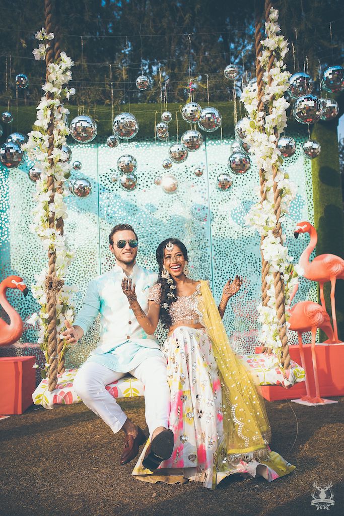 Photo of Mehendi couple portrait with hanging glass balls and swing