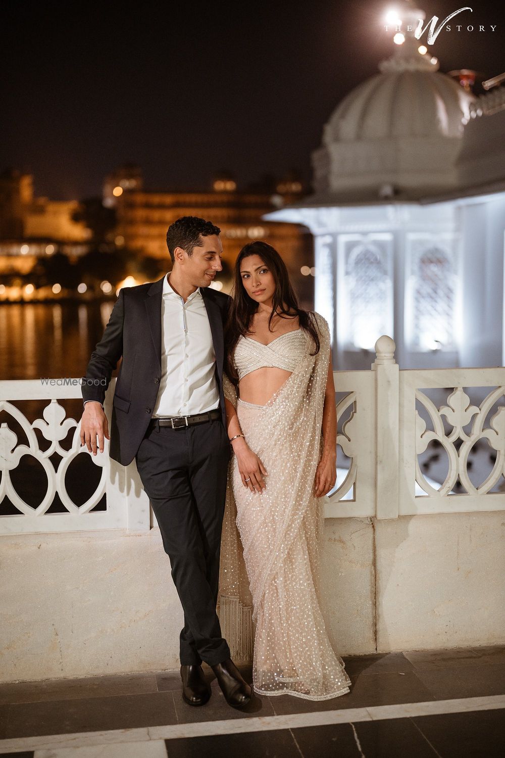 Photo of Couple portrait with the bride in a glam white net saree with a bustier style blouse for her pre-wedding event