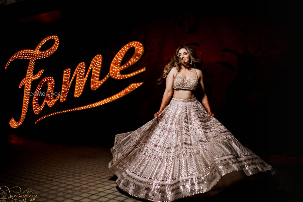 Photo of Bride twirling in a silver lehenga for her sangeet