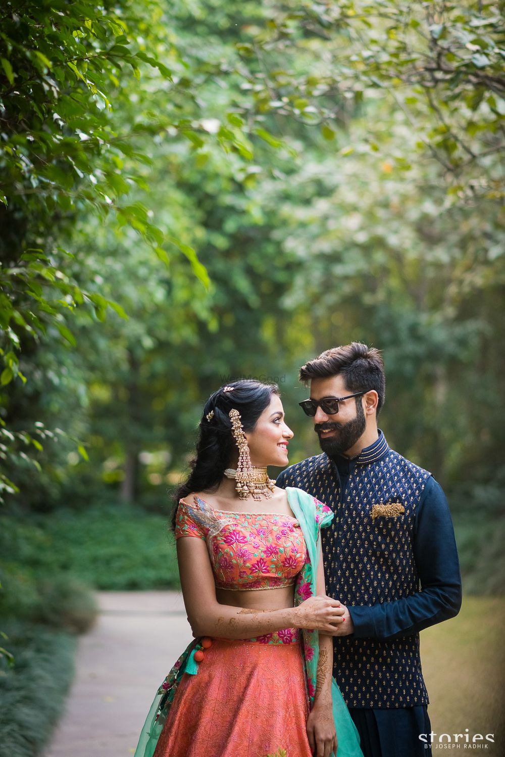 Photo of Mehendi bride and groom with contrasting outfits