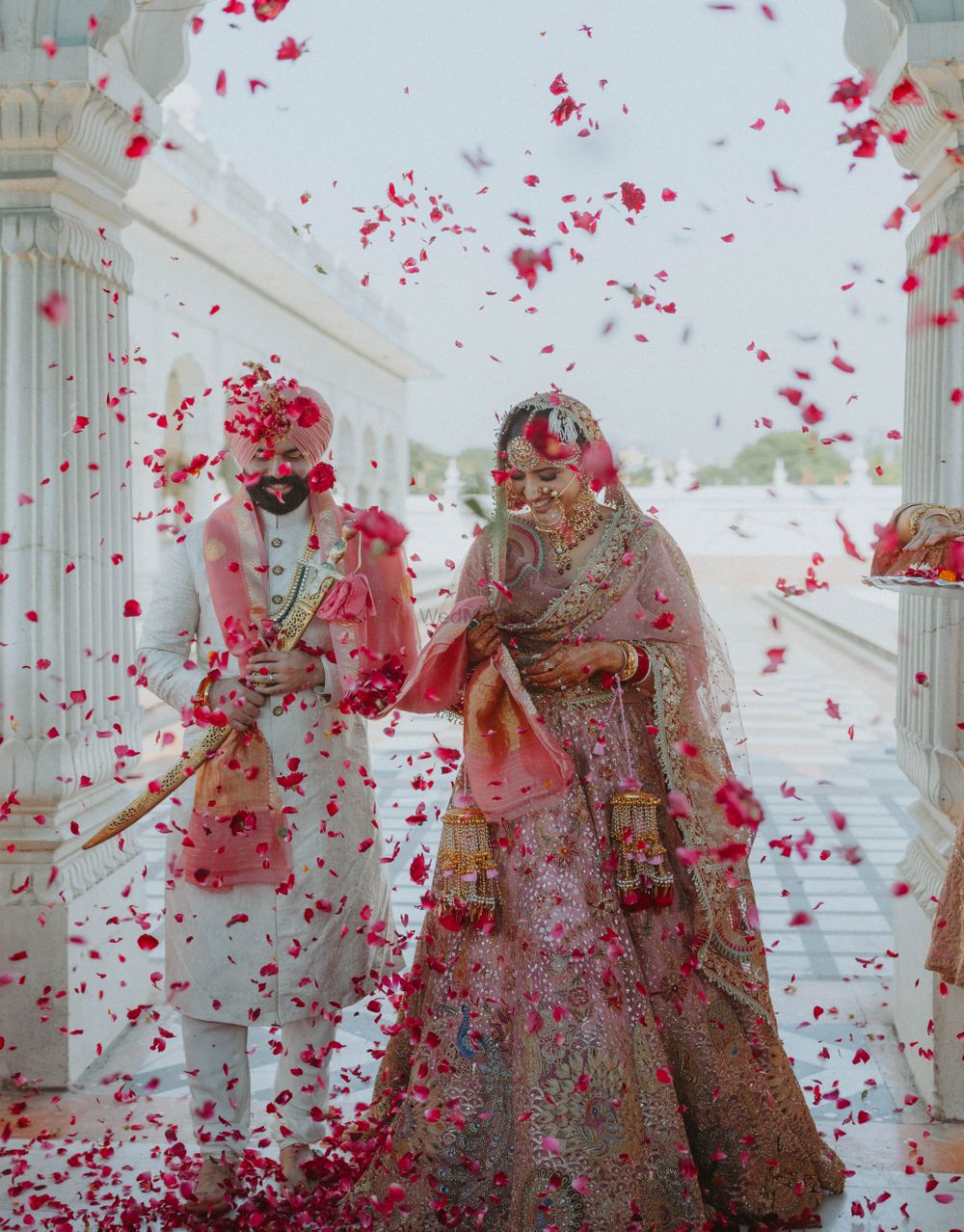 Photo of flower shower on couple during their wedding day