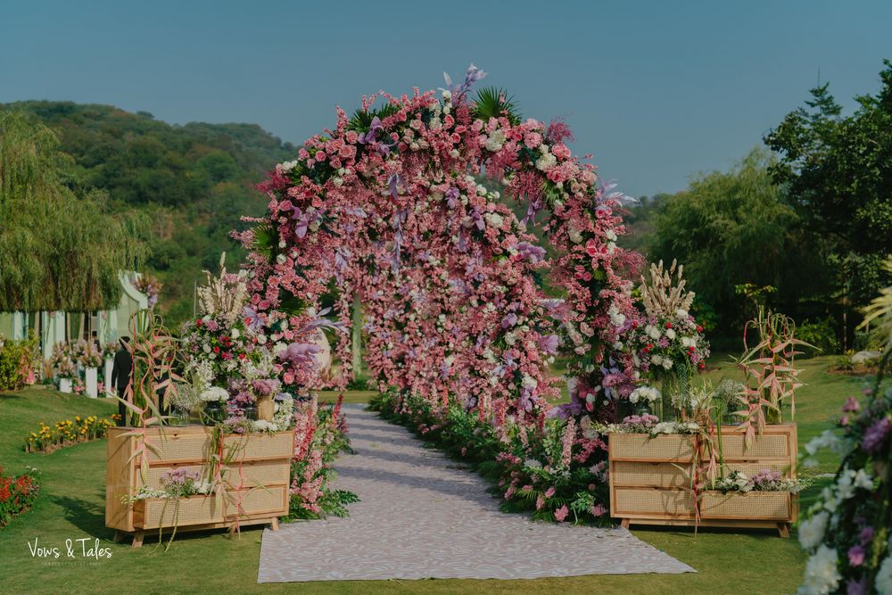 Photo of Lovely arch style entrance decor with pink and white florals