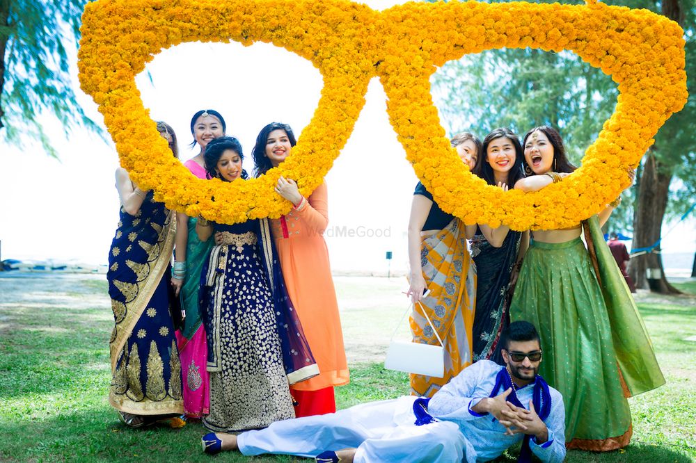Photo of Mehendi sunglasses photobooth with bridesmaids and groom
