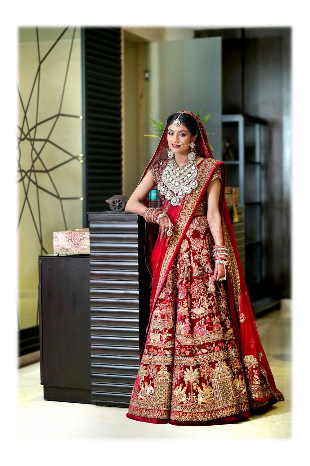 Photo of A bride in a maroon lehenga and exquisite jewellery