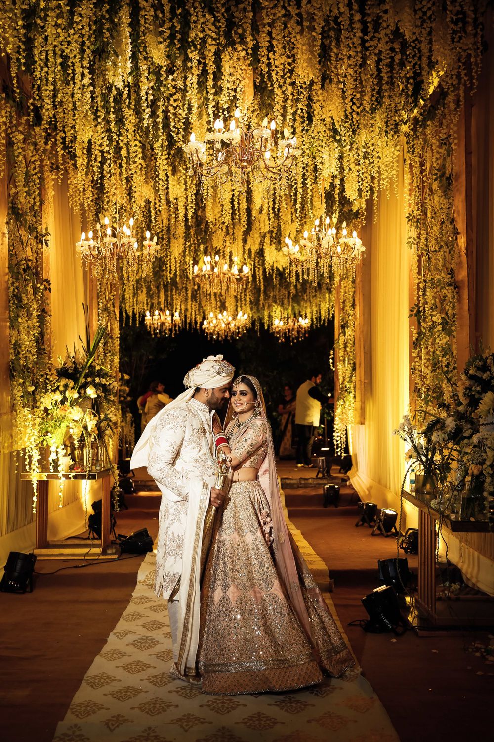 Photo of couple portrait against grand wedding decor