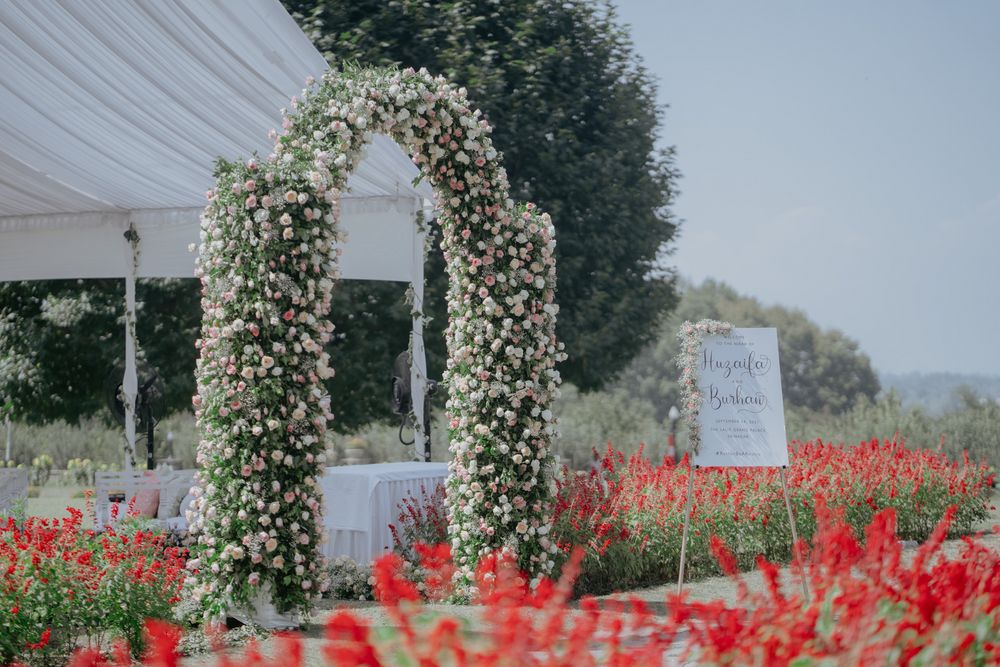Photo of floral arches with intertwined greenery