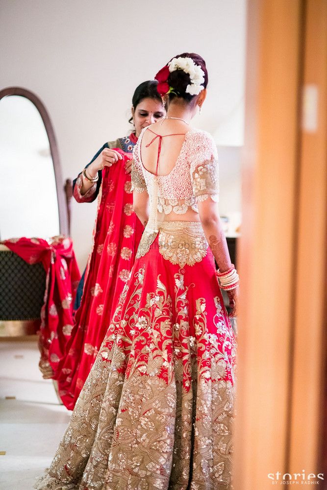 Photo of Red and pink lehenga by Anamika Khanna