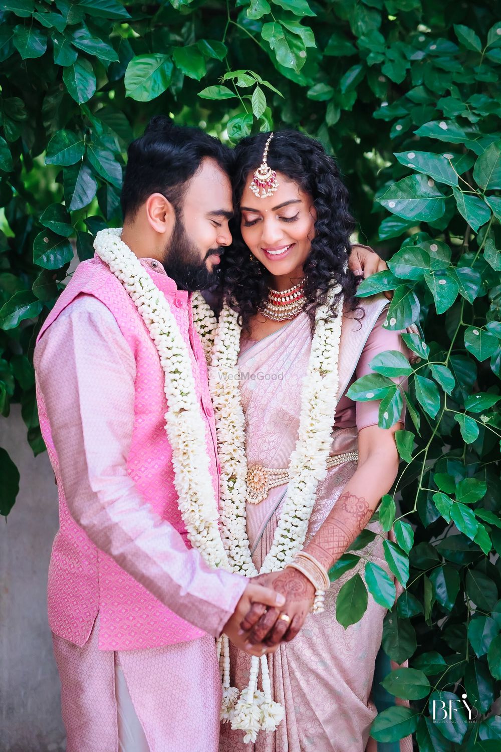 Photo of happy couple wearing varmala shot