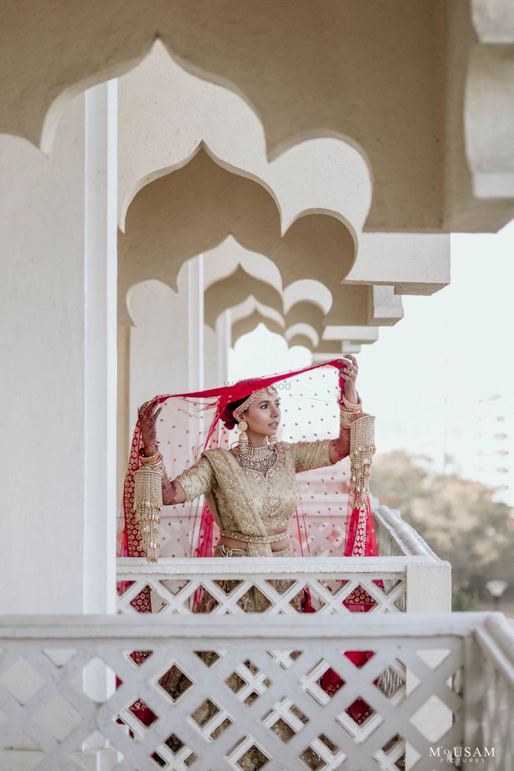 Photo of bridal portrait putting her contrasting double dupatta