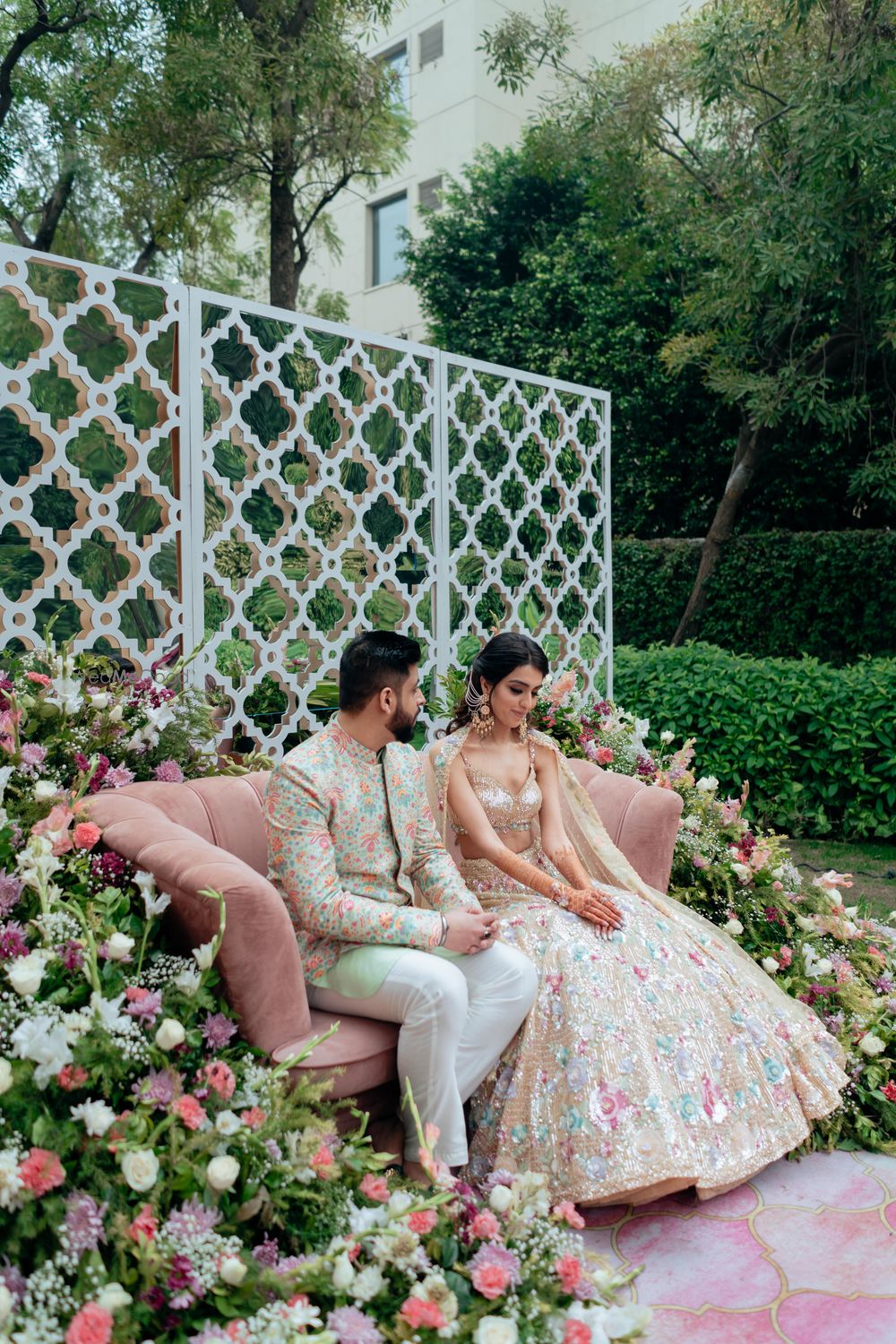 Photo of pretty pastel theme sangeet decor with florals