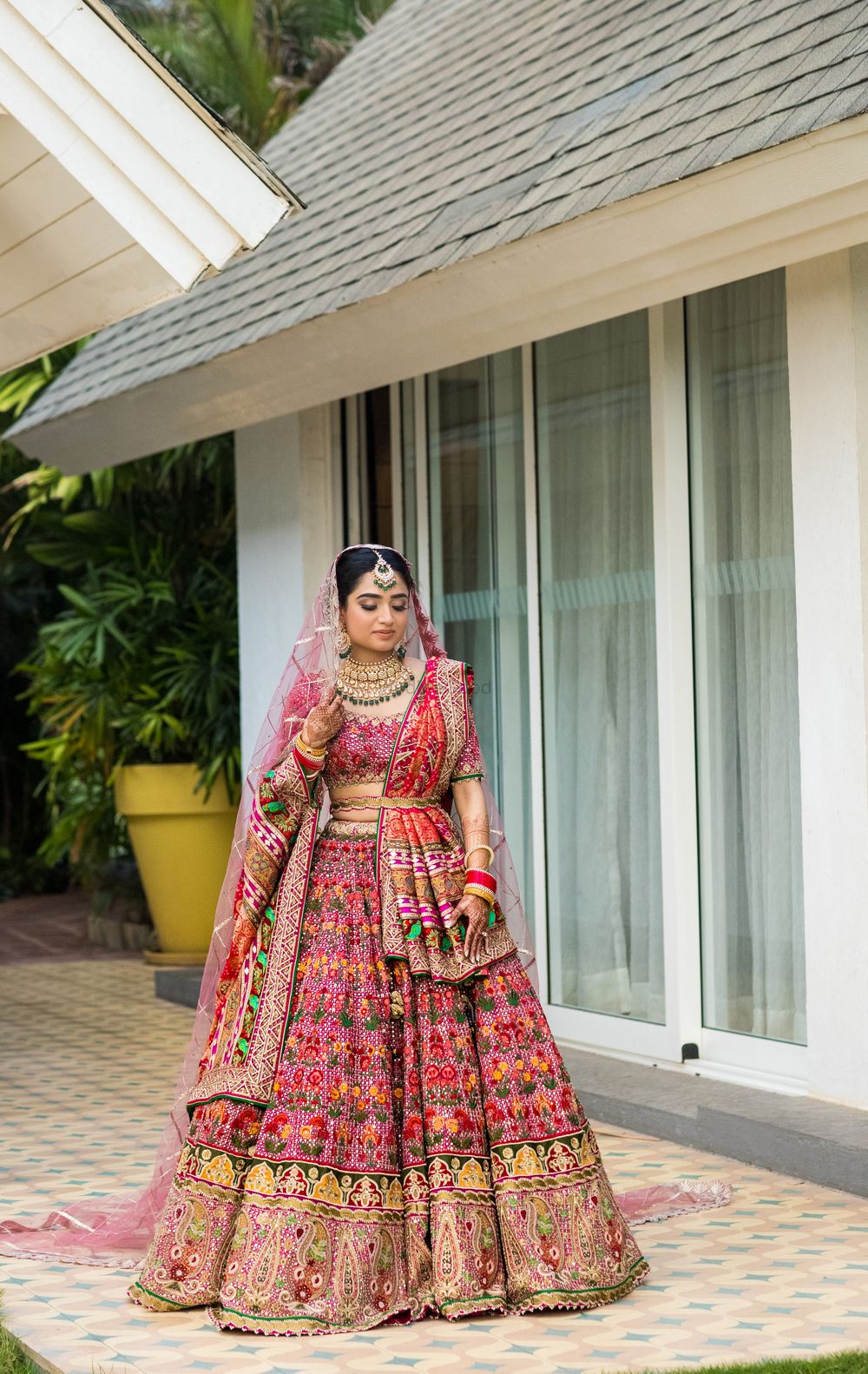 Photo of Bride in a multi-colored wedding lehenga