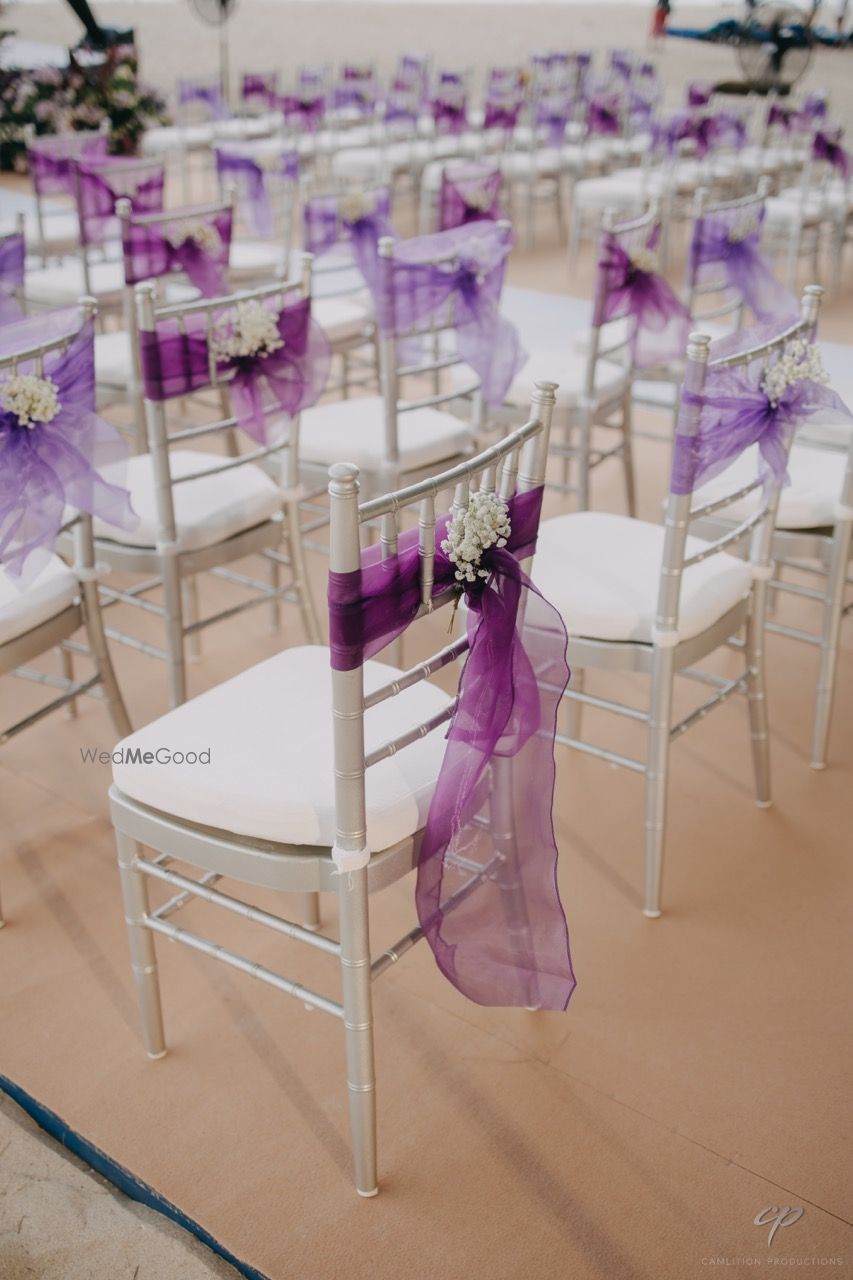 Photo of Purple and lavender ribbon decor with baby breath for chair backs