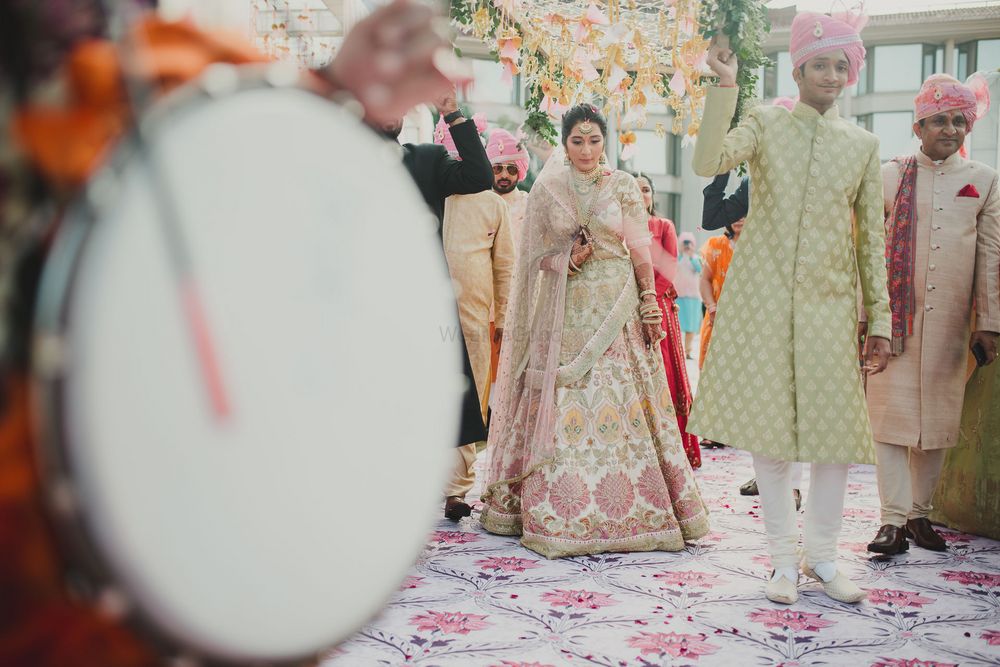 Photo of A beautiful bridal entry under a gorgeous phoolon ki chaadar