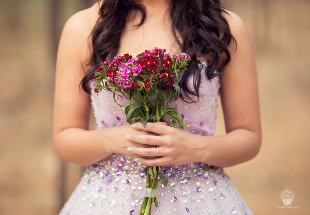Photo of Pre wedding shoot with bride holding bouquet