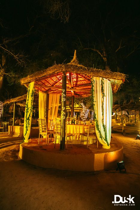 Photo of rustic temple mandap with white and green drapes