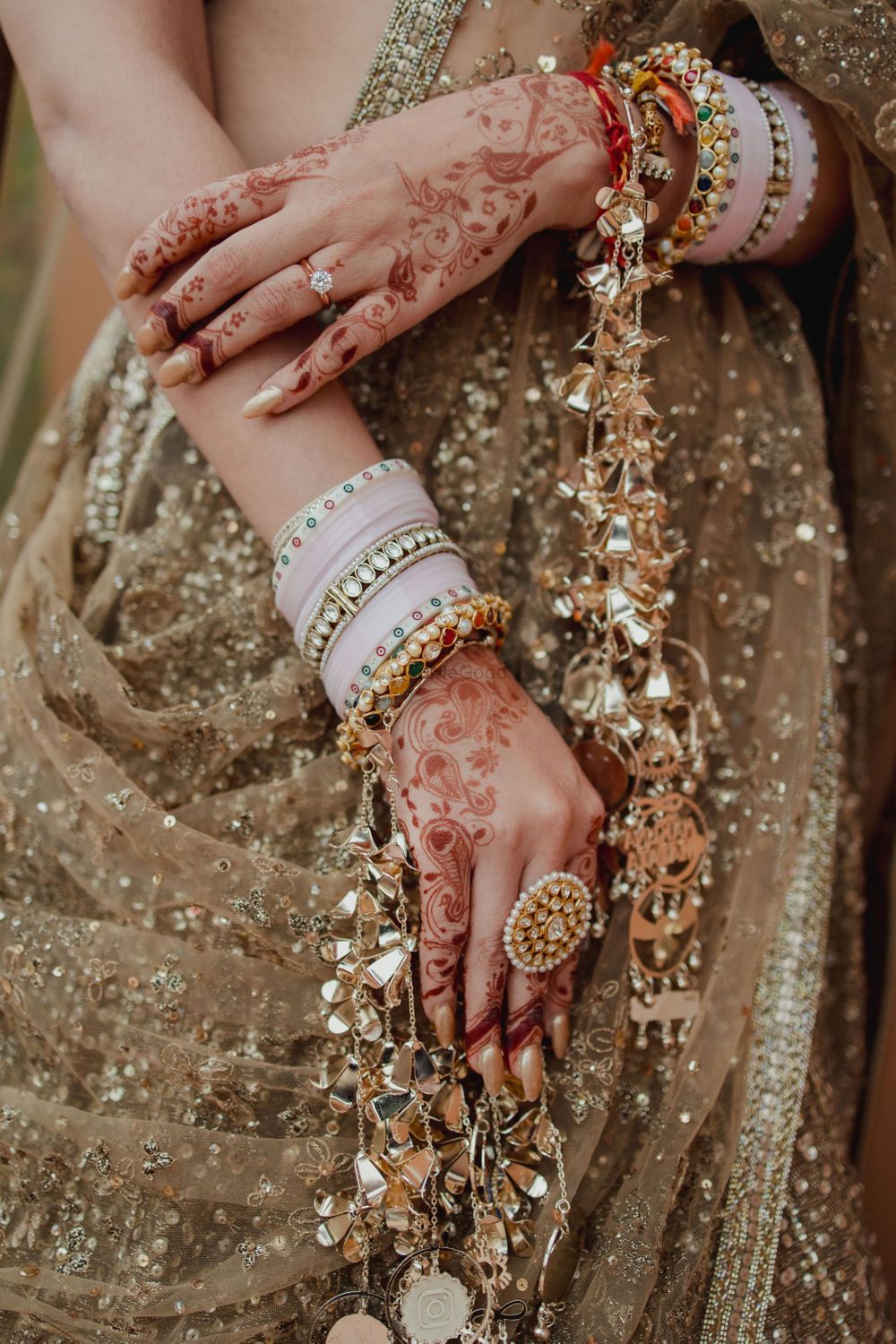 Photo of Lovely closeup shot of the bridal mehendi and light pink chooda and a statement ring