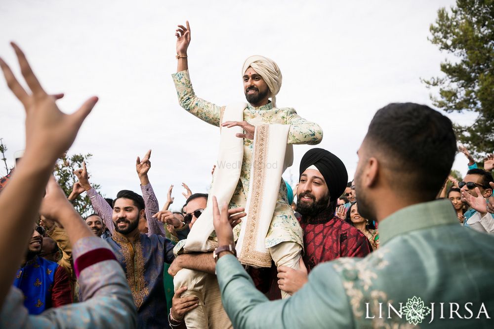 Photo of Groom entering on brothers shoulders