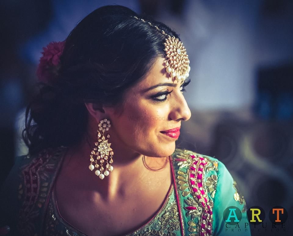 Photo of Bride in Turquoise Blouse and Polki Earrings