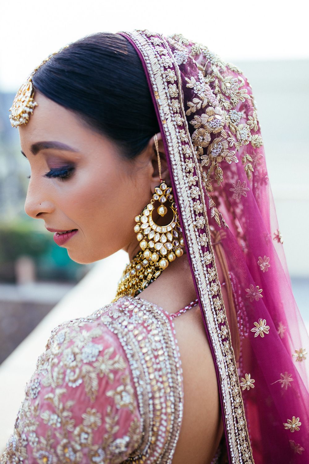 Photo of Stunning side profile of a bride wearing gold earrings