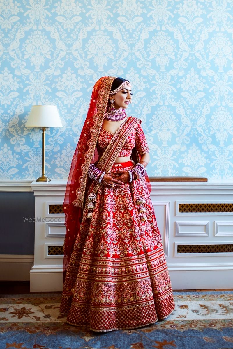 Photo of Bride wearing a red bridal lehenga.