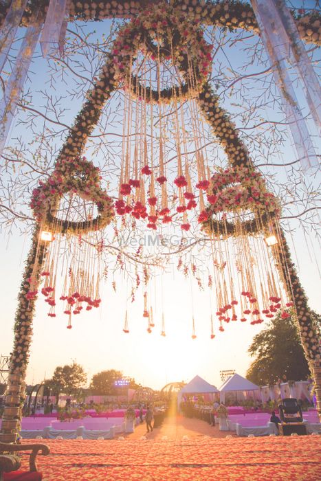 Photo of Floral chandeliers suspended from mandap