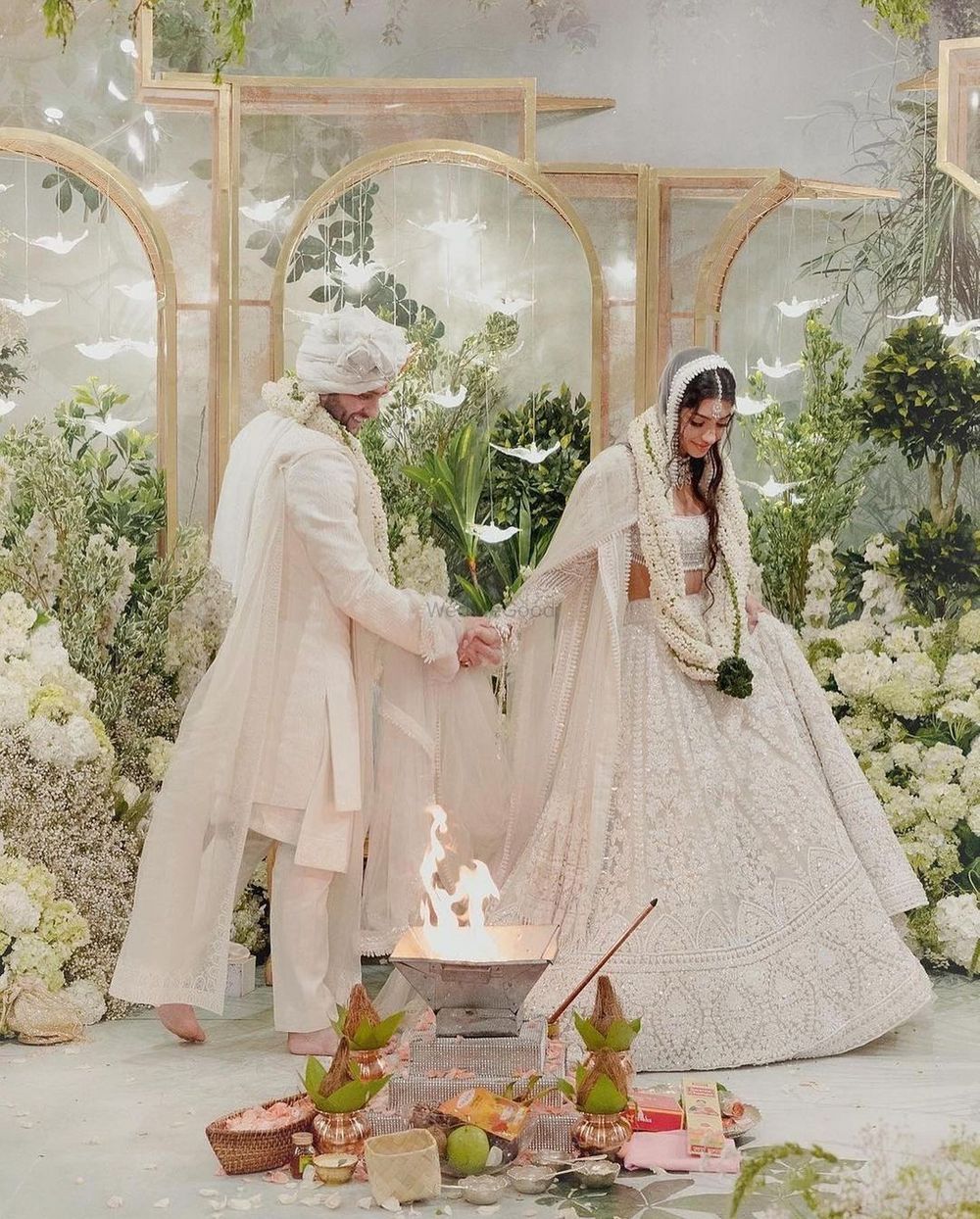 Photo of Alanna and Ivor in white custom Manish Malhotra outfits on their wedding day