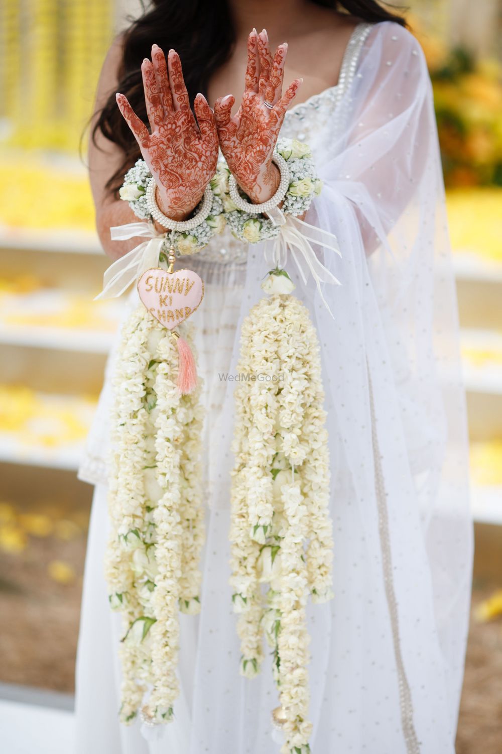 Photo of bride wears wedding hashtag on her haldi jewellery