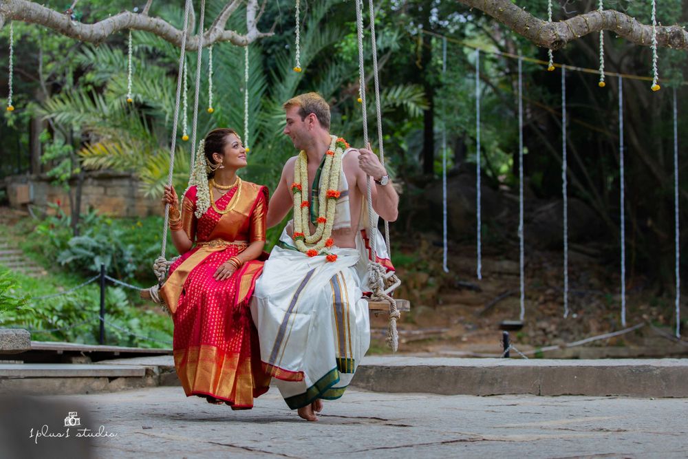 Photo of A south indian bride and groom on their wedding day, swinging on a swing