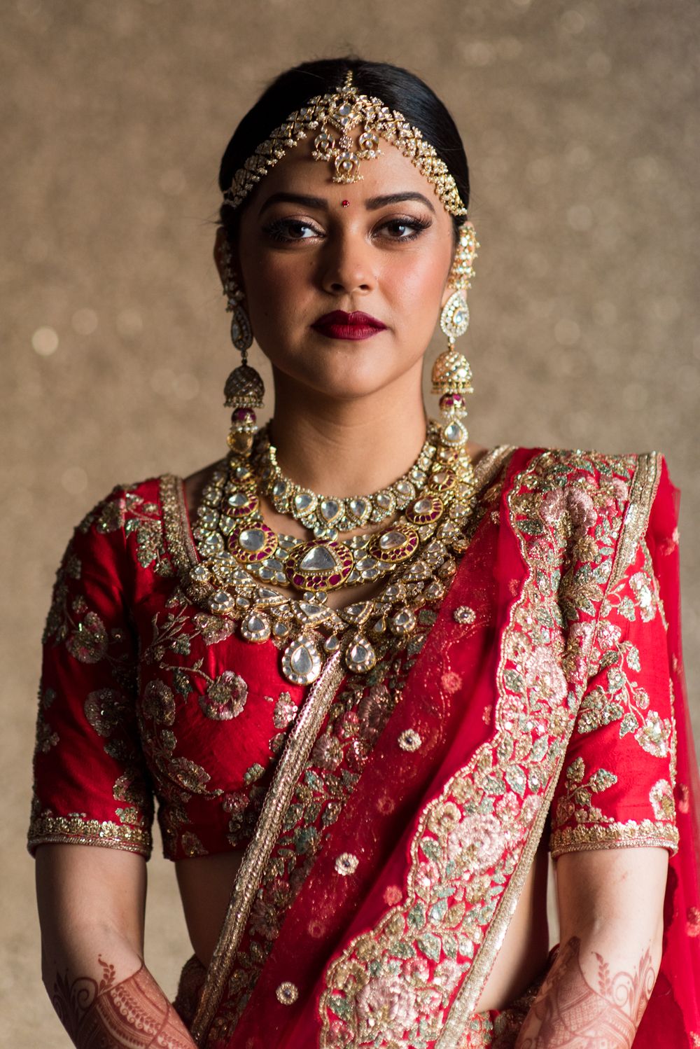 Photo of Modern bridal portrait in red and gold lehenga