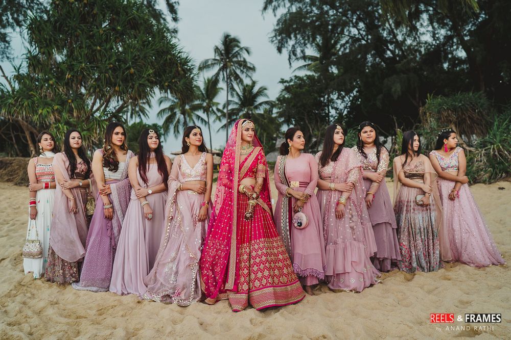 Photo of Bride with coordinated bridesmaids on wedding day