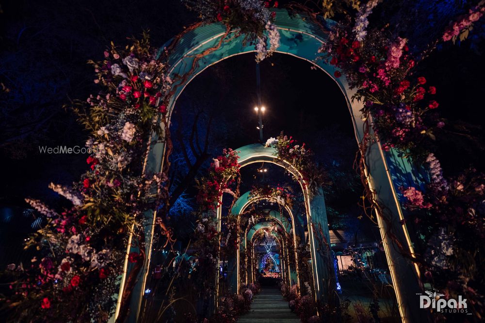 Photo of Arch ways lit up with gorgeous lights and floral decor for the sangeet night