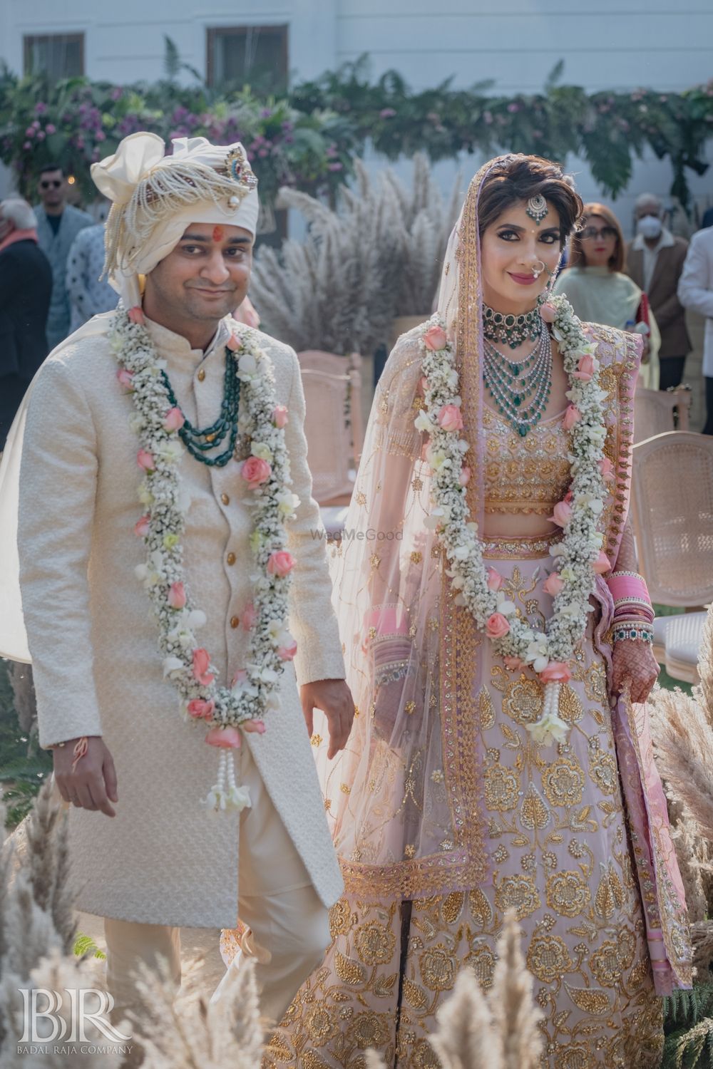 Photo of pastel bride and groom wearing unique jaimalas