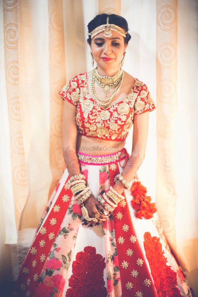 Photo of Unique red and white bridal lehenga with panels