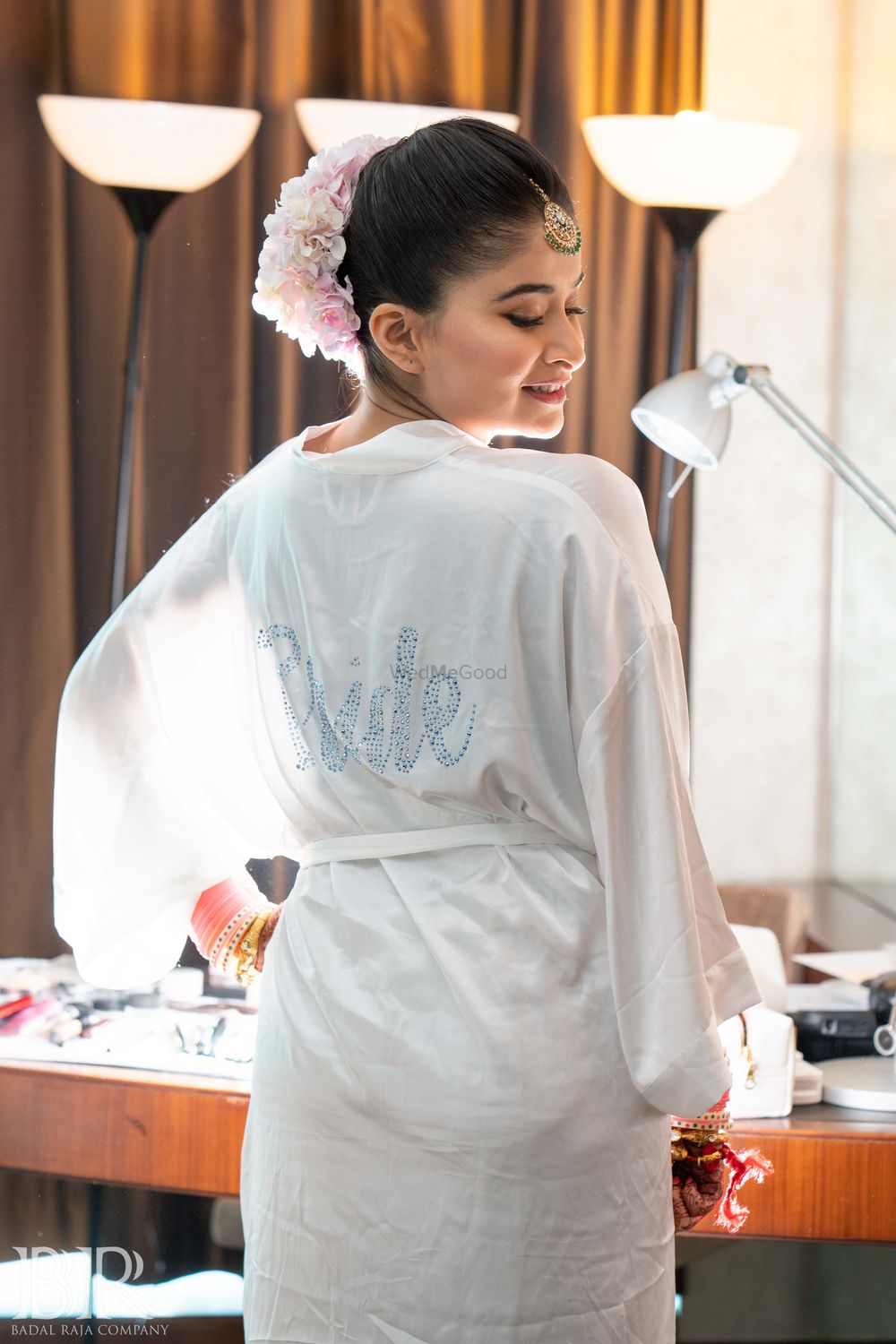 Photo of Bride wearing bridal robe in white