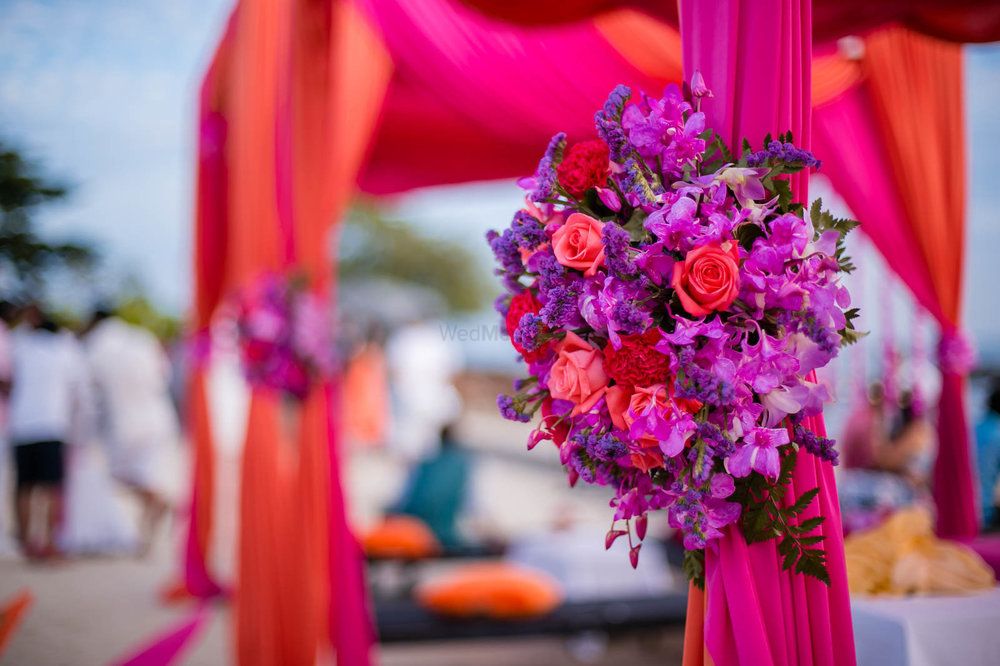 Photo of Bright purple and pink floral decor for a wedding function