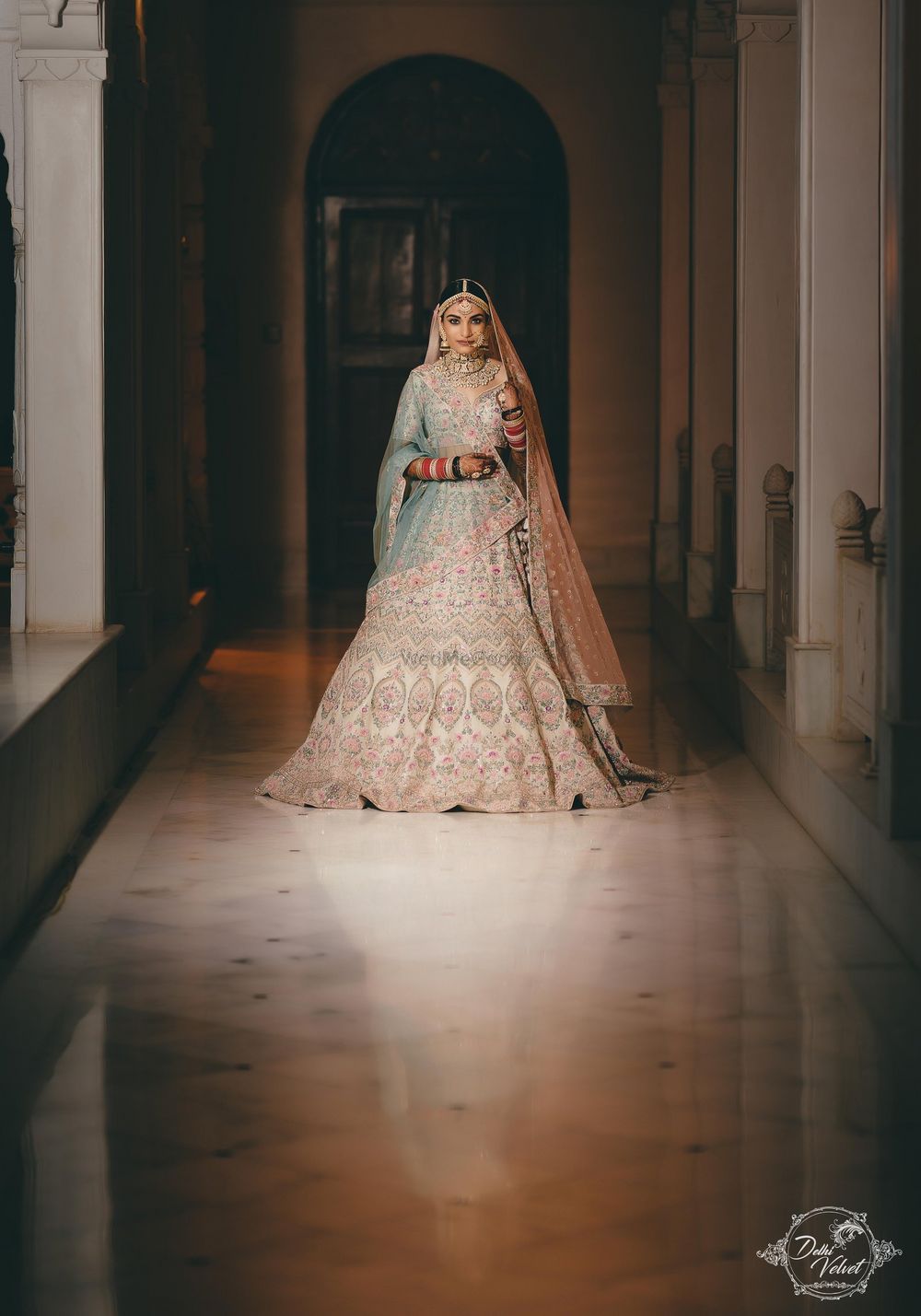 Photo of An elegant bride in a beautiful pastel lehenga on her wedding day.