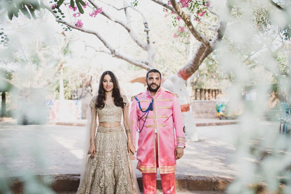 Photo of Bride and groom in gold and pink